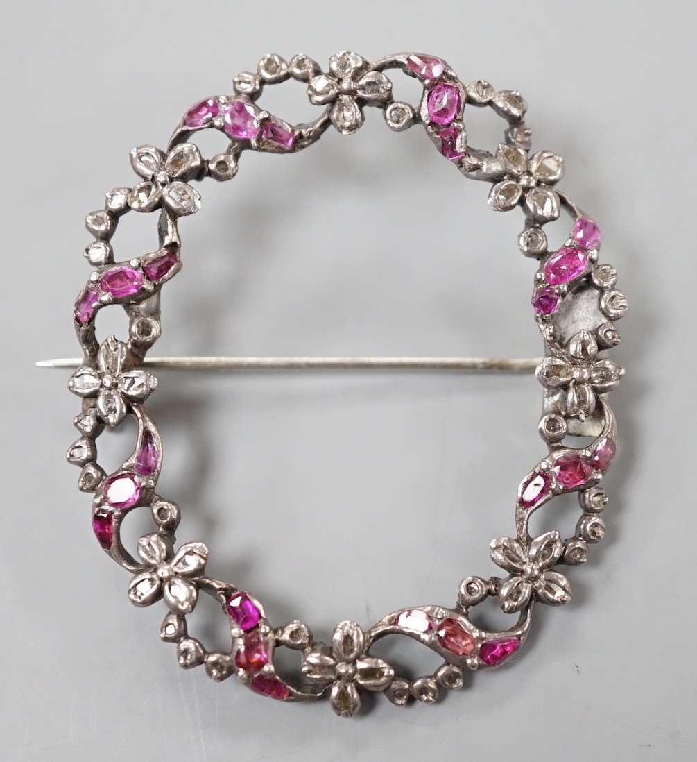 A 19th century white metal rose cut diamond and ruby set open work oval wreath brooch, 44mm.